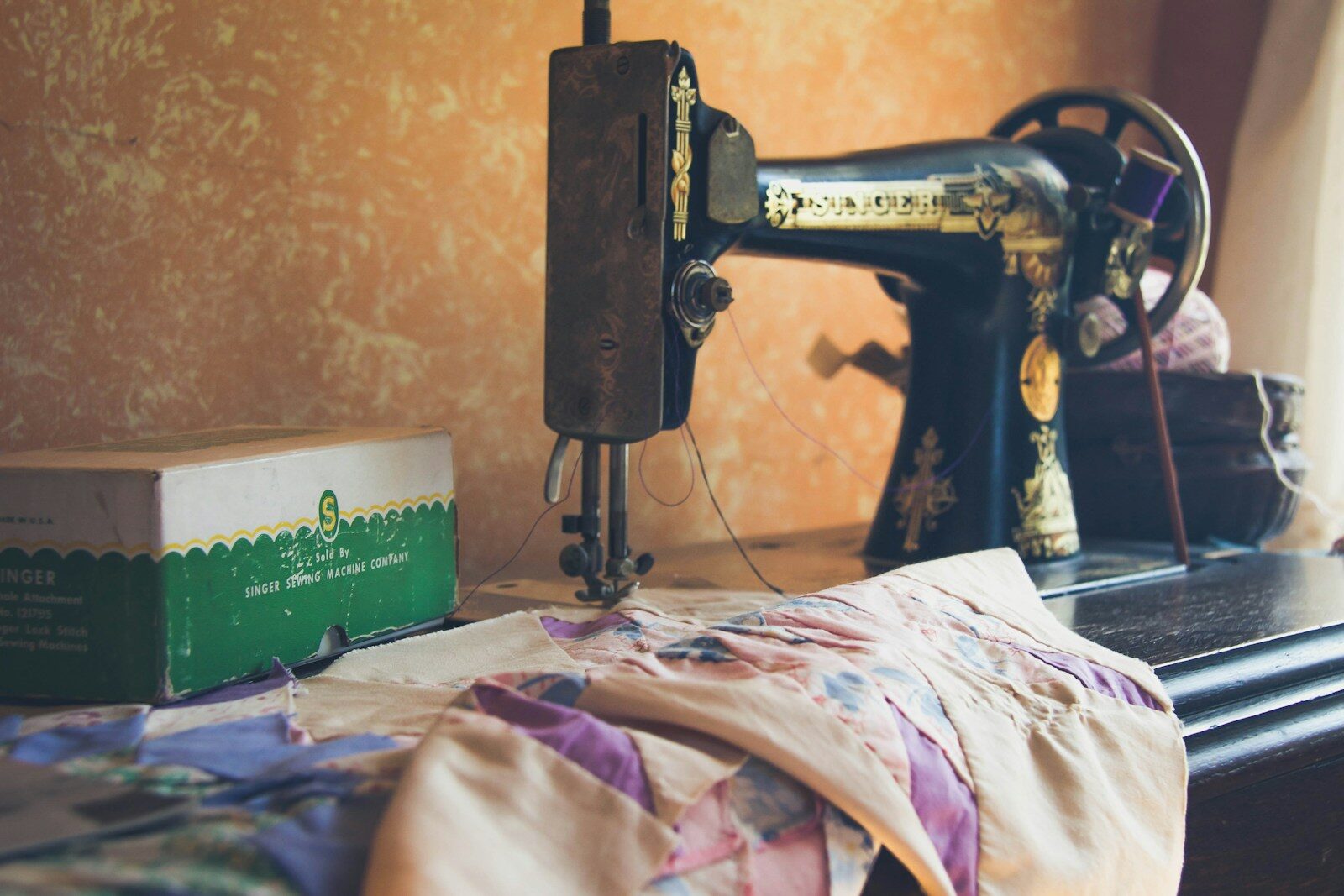 black sewing machine on white and pink floral textile