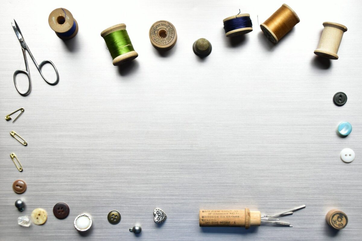 a table topped with lots of different types of sewing supplies